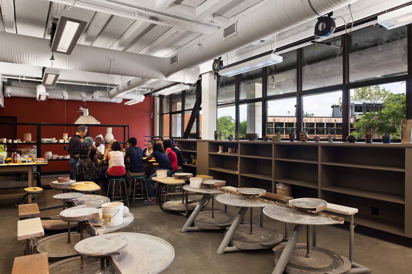 <p>Operable windows replaced glass block in the former boiler room—now a 3D art studio—allowing light and air to flow in and opening eastward views to the Middle School. <br><small>&copy; Michael Moran/OTTO</small></p>