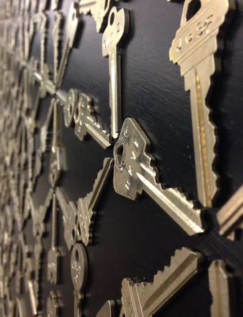 Detail of keys adhered to wood backing.